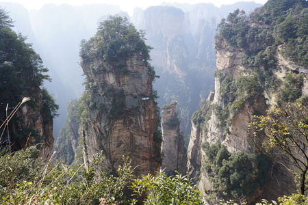 Mountains in China with trees and dust in sunshineの写真素材