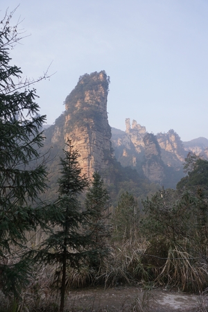 Mountains in China with trees and dust in sunshineの写真素材