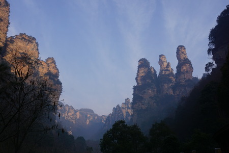 Mountains in China with trees and dust in sunshineの写真素材