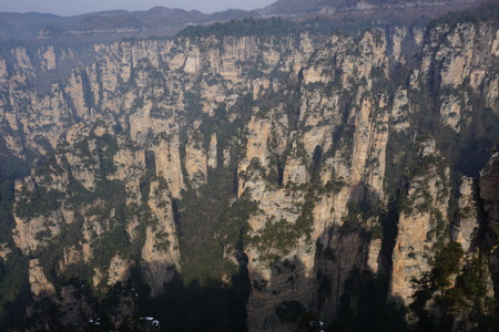Mountains in China with trees and dust in sunshineの写真素材