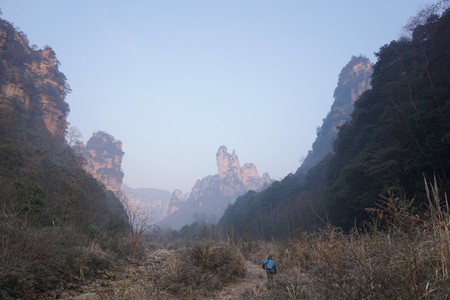 Mountains in China with trees and dust in sunshineの写真素材