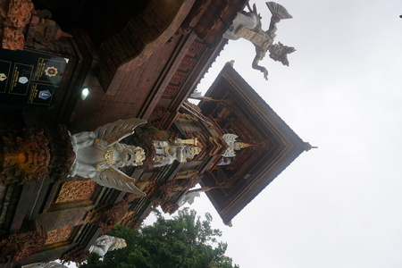 Balinese temple gate entrance statue with plants in Bali Indonesiaのeditorial素材