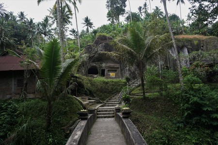 Bridge through the jungle in a stone temple Bali Indonesiaの写真素材