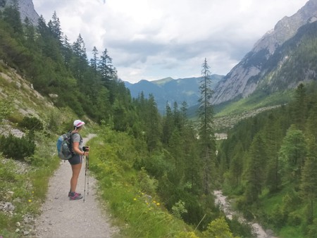 Hiker girl enjoying the view in the green mountains with treesのeditorial素材