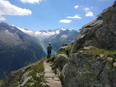 Hiking girl with backpack enjoying the view from the mountains and lakeのeditorial素材