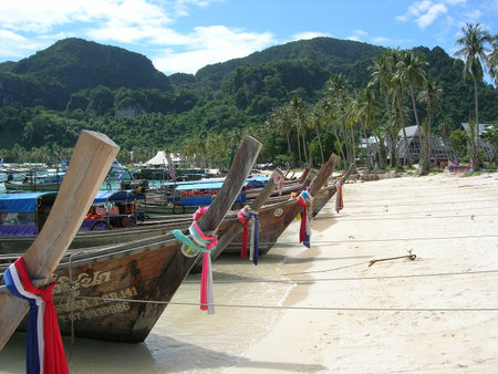 Touristboats on the beach at Phi Phi Don,Thailandの写真素材