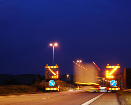 Night shot of a big truck driving through a road construction site