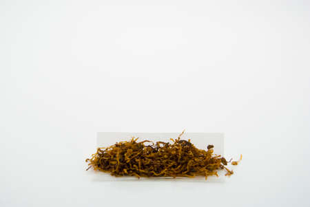 A little pile of rolling tobacco in rolling paper for making home made cigarettesの写真素材