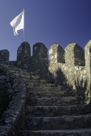 Castle stairs leading up to a white flag.の写真素材