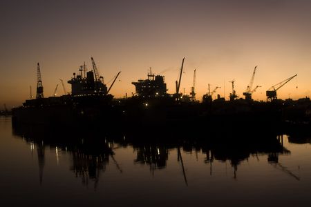 Large ships standing in docks at sunsetの写真素材