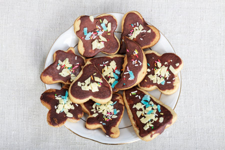 Cookie with chocolate and colorful decoration on white plateの写真素材