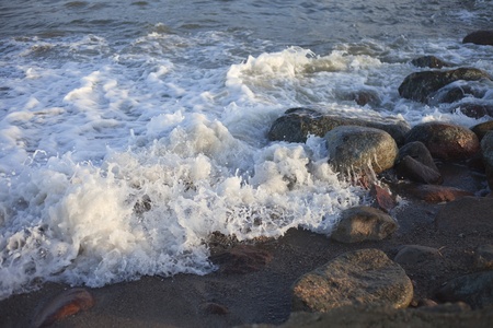 Stones in waves.の写真素材