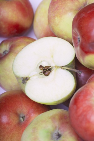Half of apple on apples.の写真素材