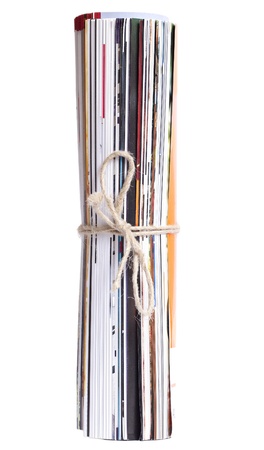 Rolled up newspaper isolated on white background.の写真素材