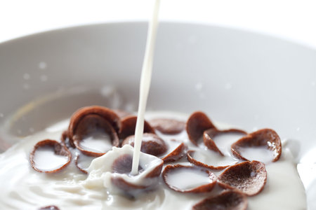 Chocolate corn flakes and flowing milk.