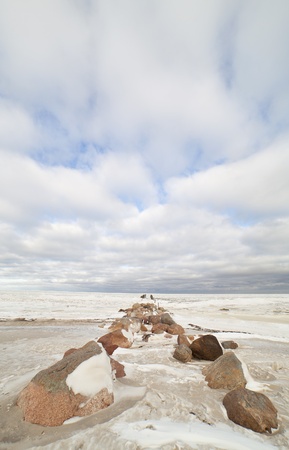Ruins of breakwater in winter の写真素材