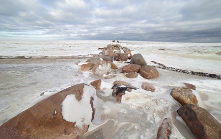Ruins of breakwater in winter の写真素材