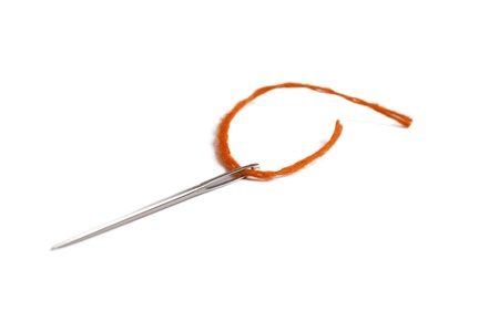 Needle and thread on white の写真素材