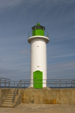 Lighthose on breakwater at coast の写真素材