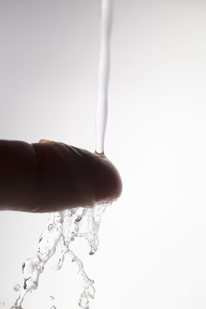 Water dropps on the finger の写真素材
