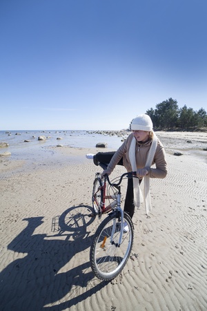 Woman and bicycle at sea の写真素材