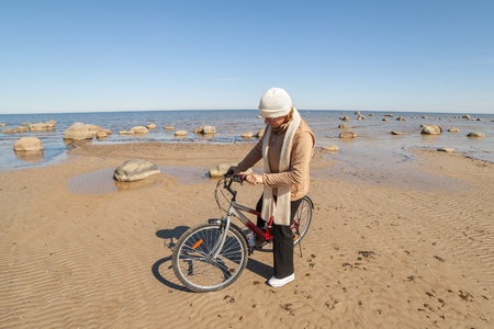 Woman cyclist at sea の写真素材