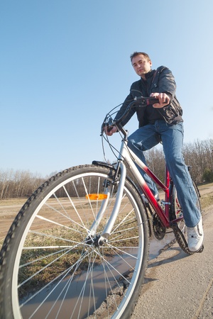 Cyclist on the road against blue sky の写真素材