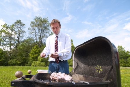 Man cooking meat on barbecue  の写真素材