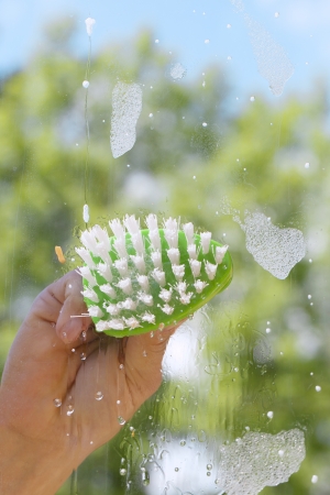 Human hand cleaning window の写真素材