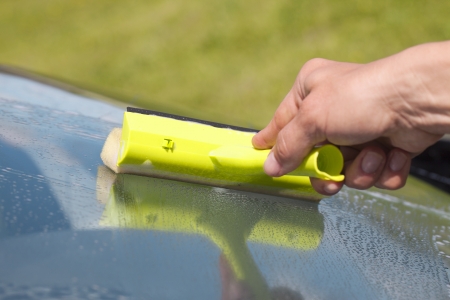 Human hand cleaning window の写真素材