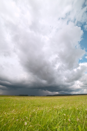 Stormy cloud over green land の写真素材