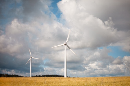 Wind turbines against stormy sky の写真素材