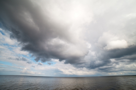 Big and dark cloud over sea の写真素材