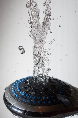 Shower head and flying water drops の写真素材