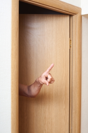 Hand in doors pointing の写真素材