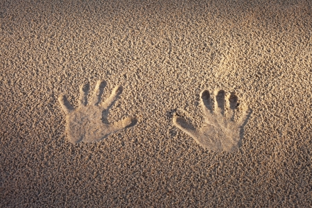 Hand prints in sand の写真素材