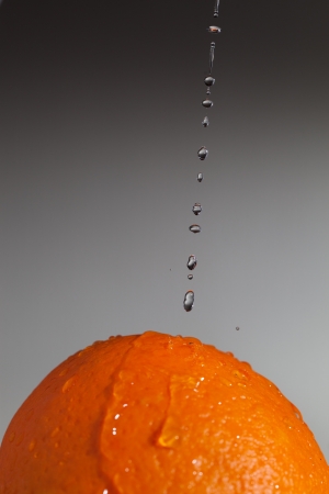Water drops and ripe orange の写真素材
