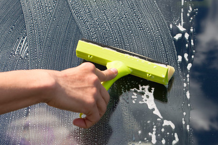 Hand washing car window 