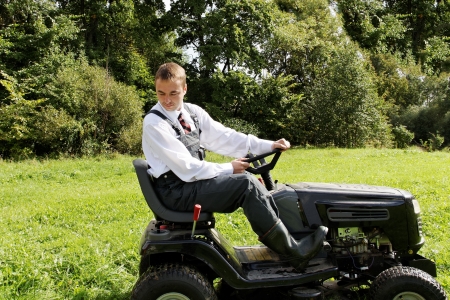 Man cutting grass in summer day の写真素材