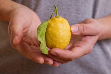 Closeup of lemon in hands の写真素材
