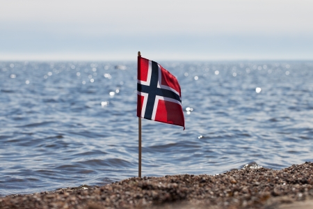 Norway flag at norwegian coast の写真素材