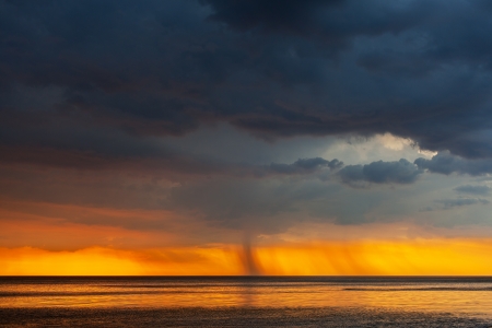 Dark clouds over sea.の写真素材