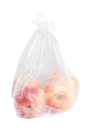 Apples in plastic bag on white.の写真素材