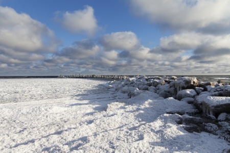 Frozen breakwater of small port in Baltic.の写真素材