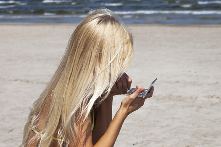 Blonde woman on the beach.の写真素材