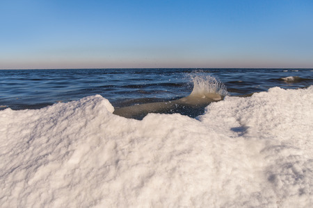 Icy waves at Baltic sea coast in winter .の写真素材