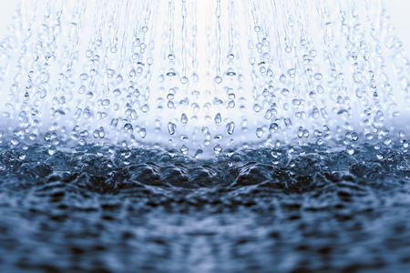 Falling and splashing water drops.の写真素材