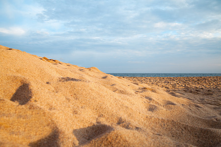Sand on Mediterranean sea beach in evening light.の写真素材