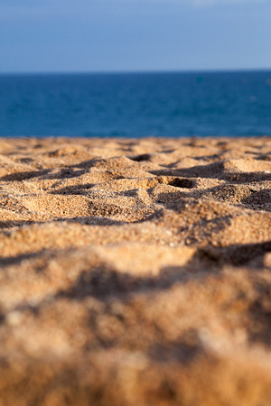 Evening sun on mediterranean beach sand.の写真素材