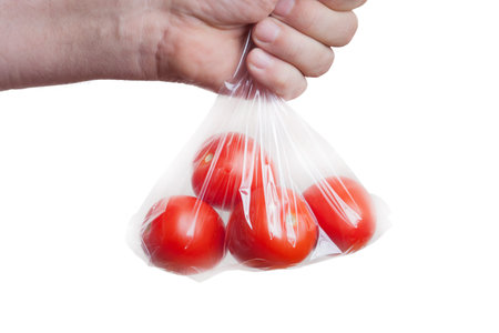 Tomatoes in plastic bag isolated on white.の写真素材
